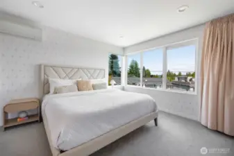 The primary bath is bathed in sunlight, offering a serene and spa-like retreat for daily relaxation.