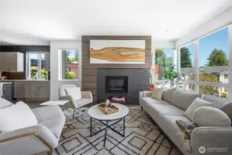 Natural light fills the room, while a gas fireplace anchors the space with warmth and charm.