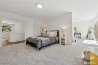 French doors open to a luxurious primary suite with adjoining sitting room and a peaceful balcony overlooking the lake.