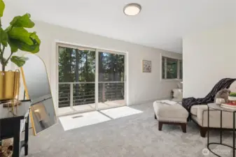 Private sitting area in the primary bedroom opens to a balcony, perfect for peaceful moments and serene views.