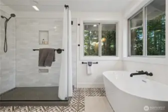 Gorgeous, fresh updated primary ensuite featuring a tile shower and soaking tub.
