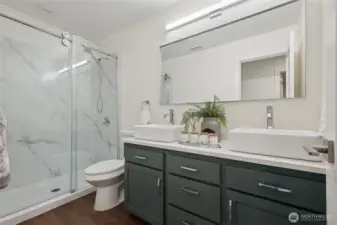 Refreshed and refined - stylish hall bathroom with a sliding glass shower door.