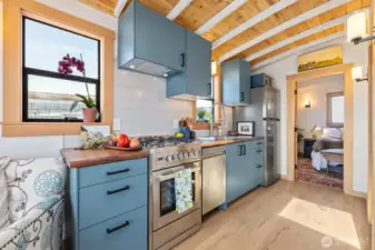 Brand new full-size appliances and whimsically teal soft-close cabinets.