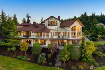The waterside exterior showcases the all-encompassing deck and expansive windows that draw the outdoors in.  Large patios, covered and uncovered, on the ground level with the executive office perched as a Crow’s Nest.  An elevator connects you to each interior level.