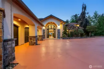 An arched entry frames the view from the front door and every room of the home.  Stone and warm lighting set the tone for the home within.