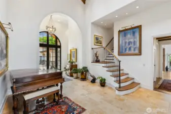 Light pours through arched windows, highlighting tumbled travertine floors and graceful transitions between levels. The chandelier is wired to lower for easy cleaner.  There are 6 strategically placed outlets so that you can light your artwork.