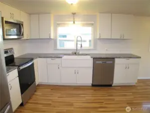 Newer appliances with farm house sink.