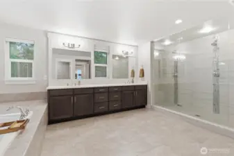 Oversized shower with double heads, double sinks, private toilet area, and plenty of floor space.