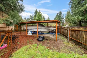 Extra covered car or boat parking in the back yard. 13911 113th Ave Ct E, Puyallup, WA 98374