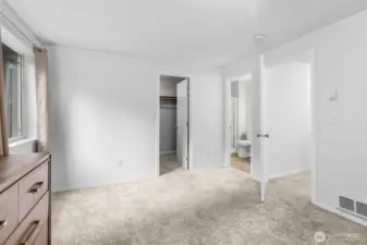 Light-filled primary bedroom with a spacious walk-in closet