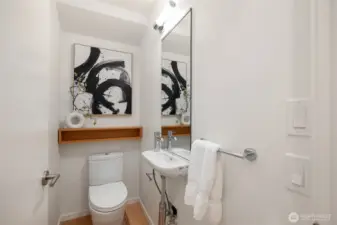 The main floor powder room adds both style and convenience, providing a tasteful and accessible amenity.