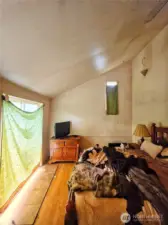 Primary bedroom with slider. Vaulted ceilings.