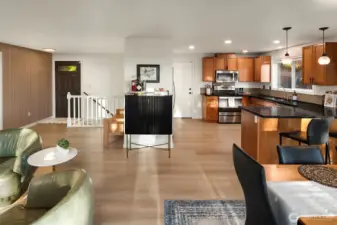 Spacious kitchen flows to dining and out to the deck with mountain views