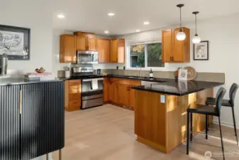 Spacious kitchen flows to dining and out to the deck with mountain views
