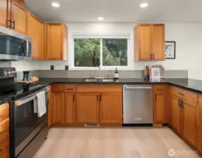 Spacious kitchen flows to dining and out to the deck with mountain views
