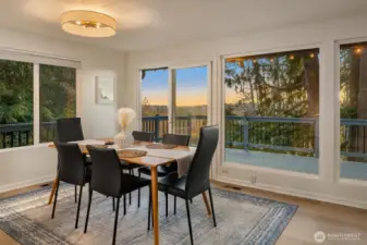 Spacious kitchen flows to dining and out to the deck with mountain views