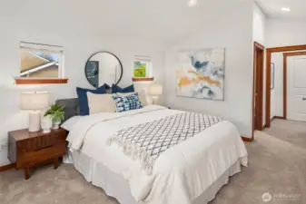 Tope floor primary bedroom boasts vaulted ceilings and skylights