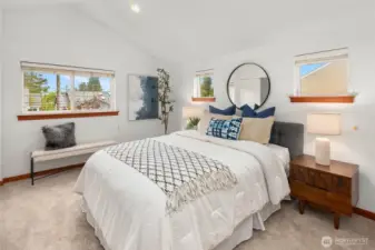 Picture windows bathe the large primary suite in natural light