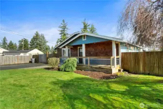 Front yard offers mature landscaping and a six-foot cedar privacy fence along the road.