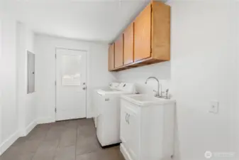 Large laundry and mudroom with utility sink. All appliances are included.