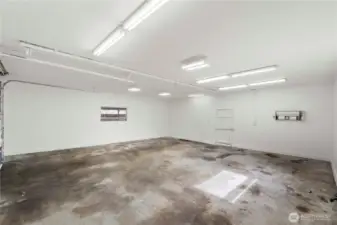 The shop boasts high ceilings, a 10-foot door, sewer and water hookups, two 220 outlets, and it is wired for a compressor with a starter box and an exterior compressor shed.