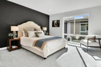 The Primary bedroom has a floor-to-ceiling window that floods the room with light, as well as a walk-in closet and its own 3/4 bath.