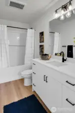 The full bath has lots of storage and serves the 2nd bedroom.