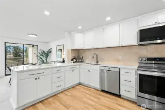 New, modern kitchen with LVP floors, Stainless Steel appliances, quartz counters, and lots of cabinet space.