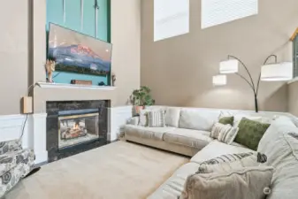 Enter to soaring ceilings and tons of light with duel fireplace leading to family room