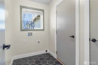 Mudroom & laundry space leads out to your two car garage! Brand new ceramic tile  flooring!