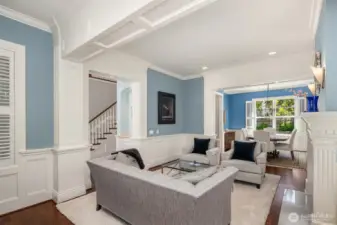 Formal living room shares southern view through dining room to gardens