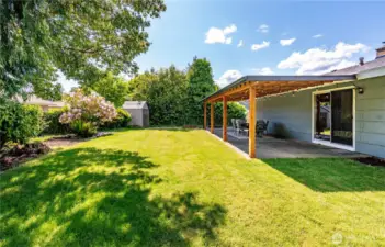 Your very own private oasis filled with lush landscape and covered area.