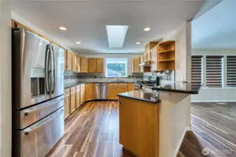 Wonderfully equipped working Kitchen with updated stainless appliances, quartz counters, and generous custom cabinetry....