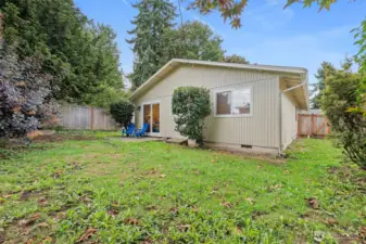 Large fenced backyard with open green space.