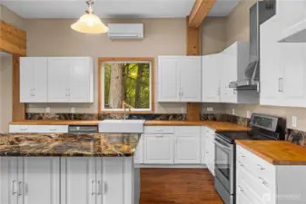 Granite and butcher block counters with ample storage.