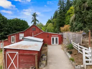 Multiple outbuildings including the main barn and guest space.