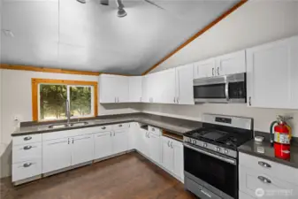 Kitchenette including range and refrigerator.