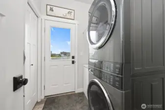 Laundry room with room for freezer, coat closet and exterior door to fenced yard.