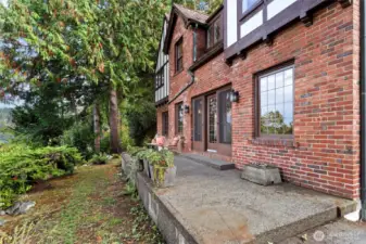 “Charming legacy home on Three Tree Point with Puget Sound glimpses, mature landscaping, and classic Northwest architectural details