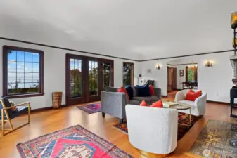 Welcoming entry into the living room, showcasing original architectural details, cozy fireplace, and abundant natural light.