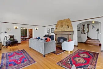 Living room fireplace accented by original wall sconces, creating a warm and inviting focal point.
