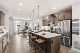 Open-concept kitchen + dining + living area.