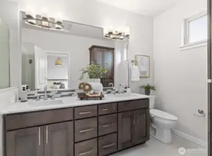 Beautiful modern full bathroom off primary suite.