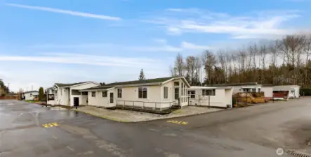 Front and Side of the home with walkway and railing from the Side Door to the Front Door.