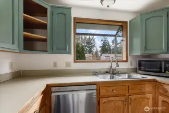 Greenhouse window above kitchen sink for plants who need a little extra sun.