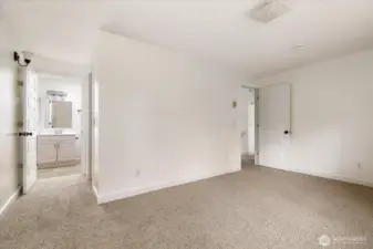 Primary bedroom with en suite bathroom and spacious walk-in closet.