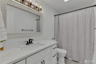 Beautifully updated bath that matches the new cabinetry and Corian countertops of the kitchen