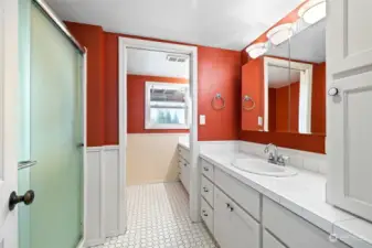 Tile floor, dual sinks, walk-in shower, separate water closet behind pocket door