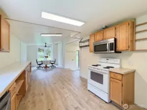 Kitchen and dining area taken from the area by the refrigerator.