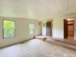 Steps up to the walk in closet and bath area of the primary.